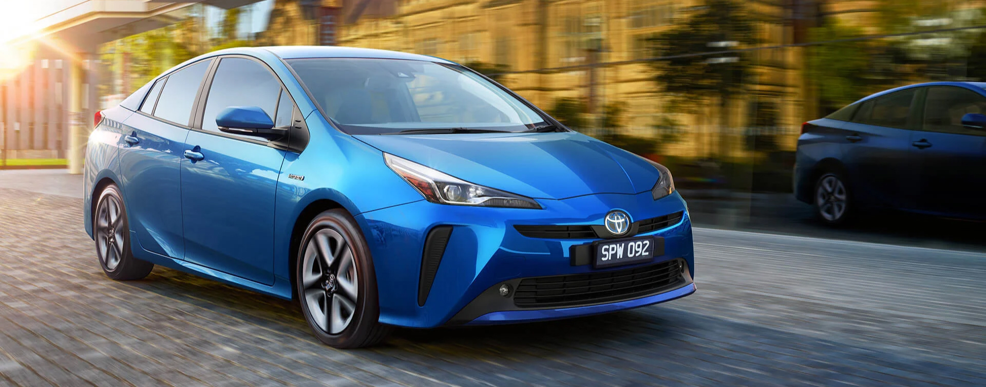 A blue Toyota Mirai zipping down a stone paved road in inner-city Melbourne, Victoria.