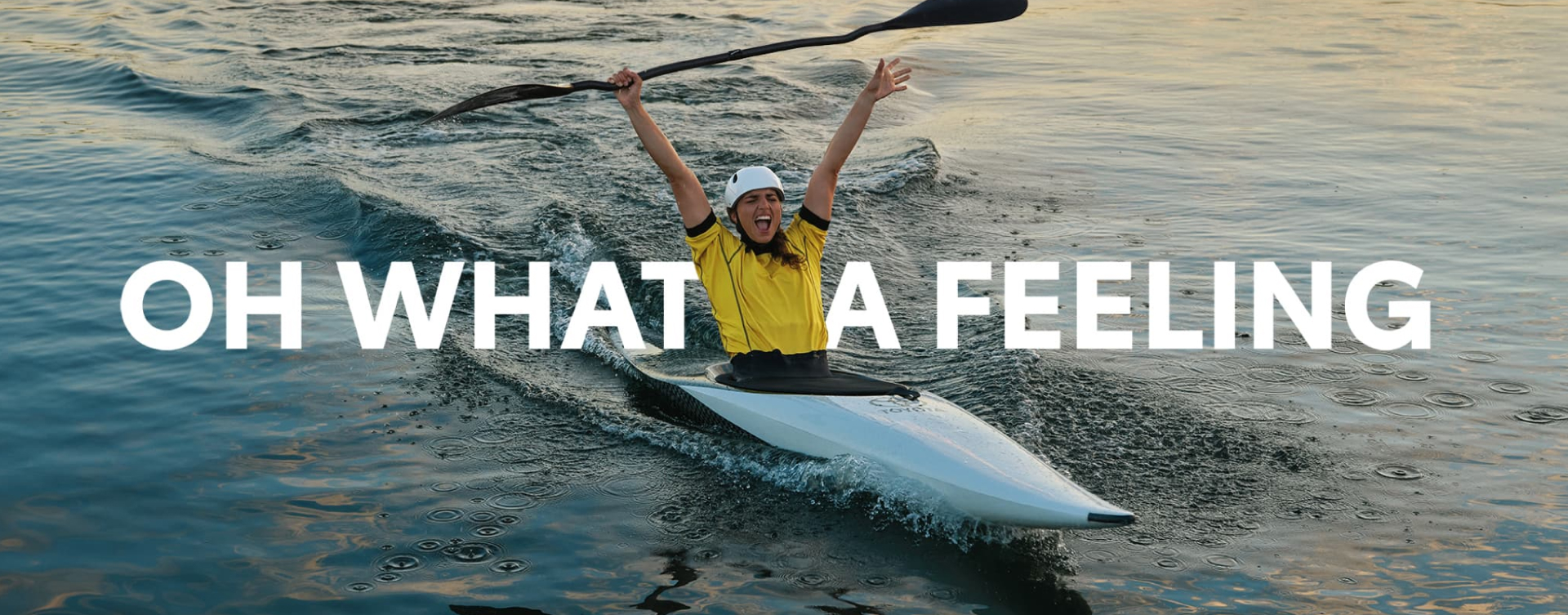 Australian Olympian canoeist Jess Fox, canoeing, raising her hands and paddle in the air in celebration. ‘OH WHAT A FEELING’ is superimposed into the image.