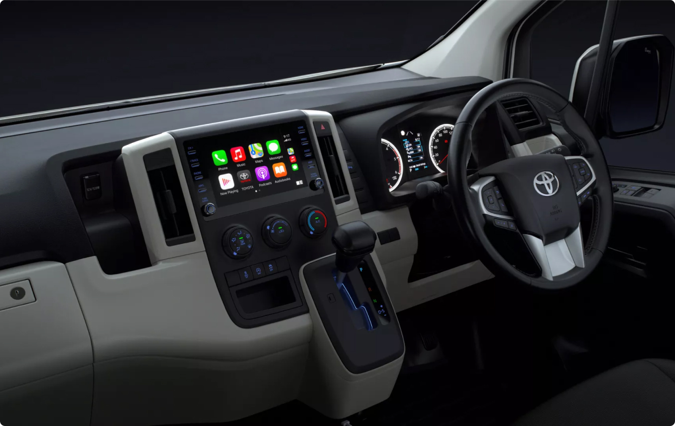 The modern interior dashboard and centre console of a Toyota HiAce.