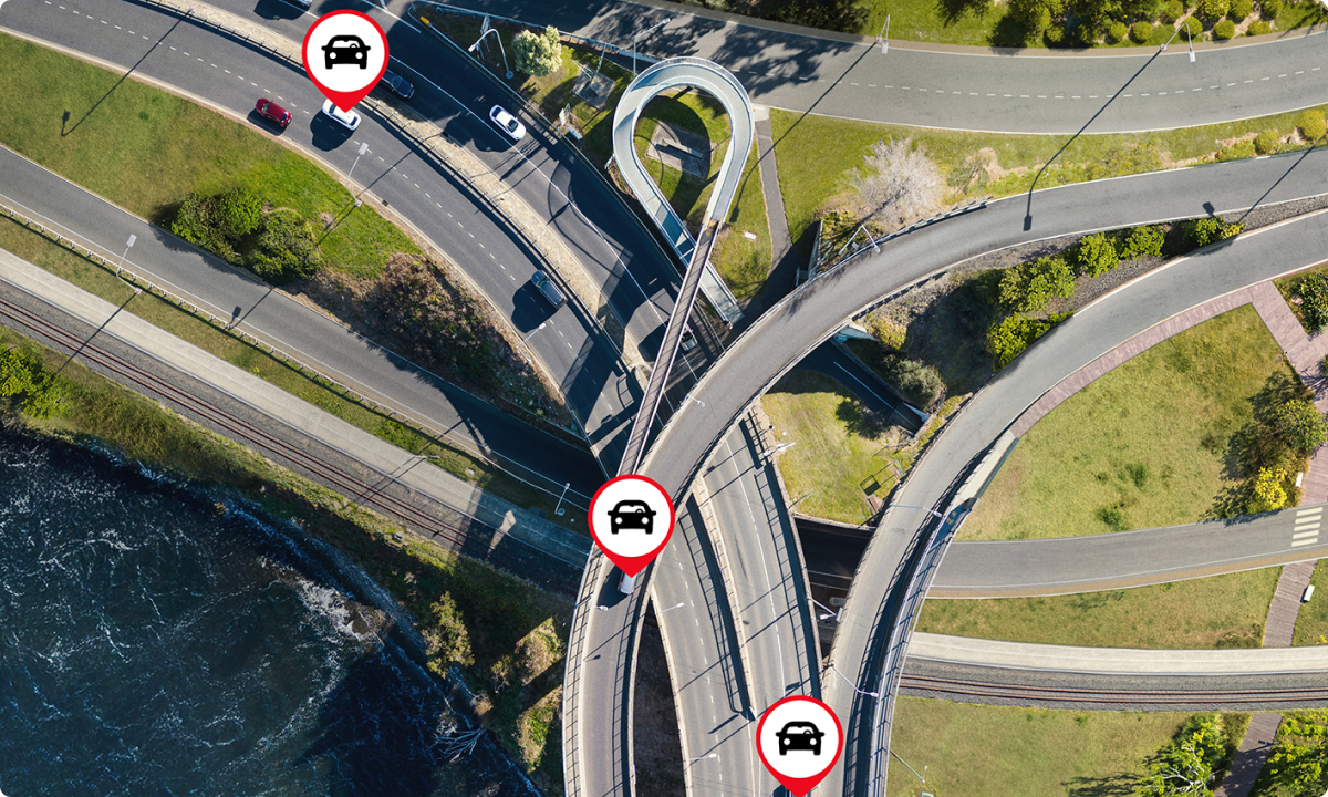 A birds eye view of overlapped and looping freeways, featuring icons of cars from Toyota Halo’s telematics software.