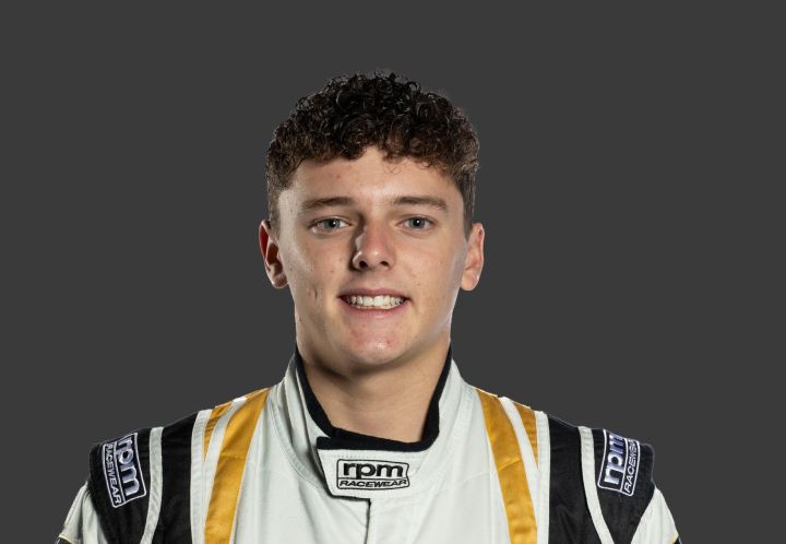 A headshot of professional T G R A driver Jett Murray in a white, black and gold racing suit against a grey background.