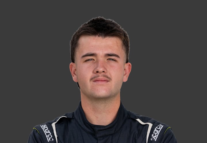 A headshot of professional T G R A driver Jack Westbury in a black and white against a grey background.