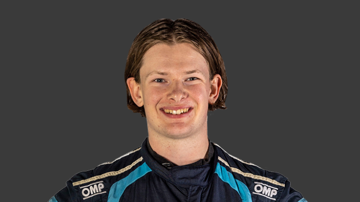 A headshot of professional T G R A driver Campbell Logan on a grey background.