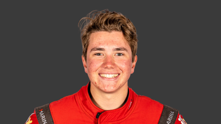 A headshot of professional T G R A driver Jarrod Hughes on a grey background.
