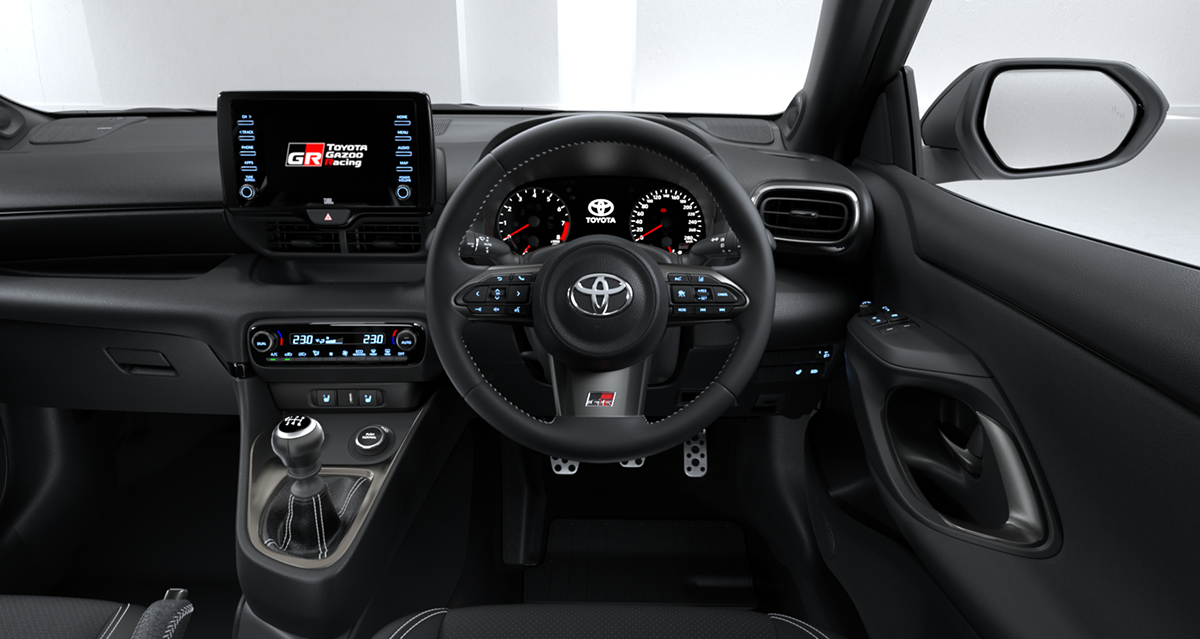 The modern black interior and dashboard of a Toyota G R Yaris.
