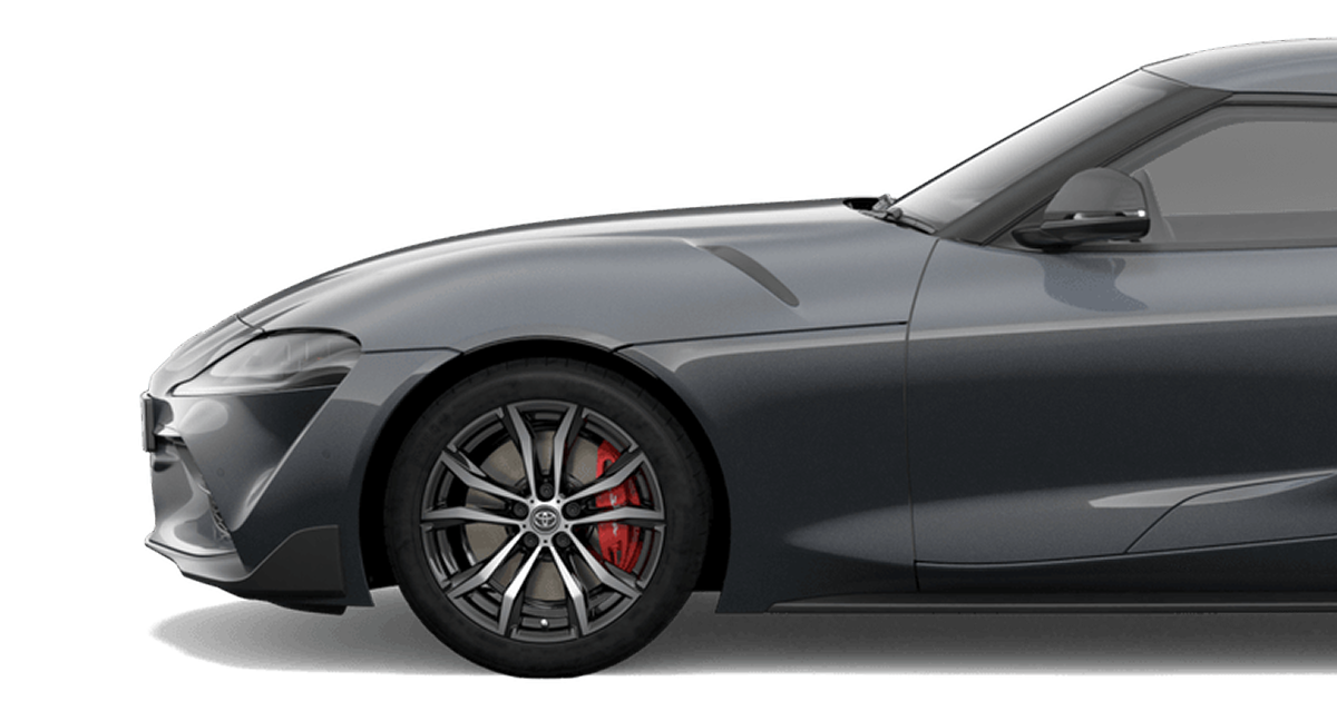 A Toyota G R Supra in Grey. Side profile with a white studio background.