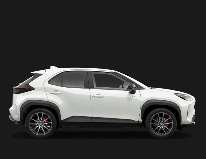 A Frosted White Toyota Yaris Cross in the G R Sport grade. Side profile with a dark studio background.