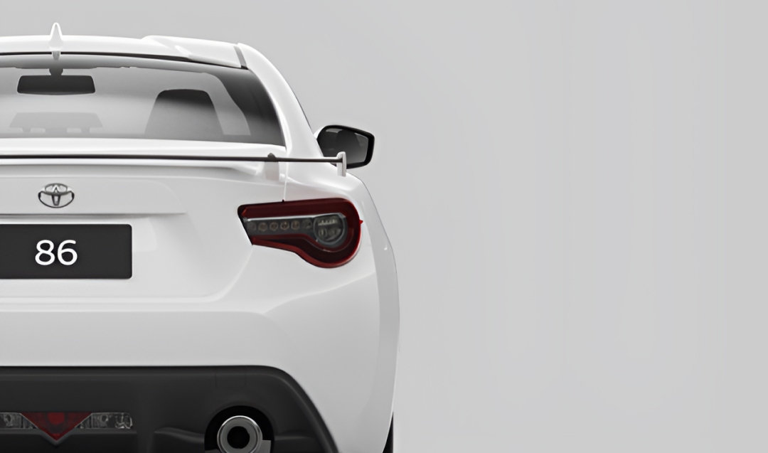 A rear-facing white Toyota 86.