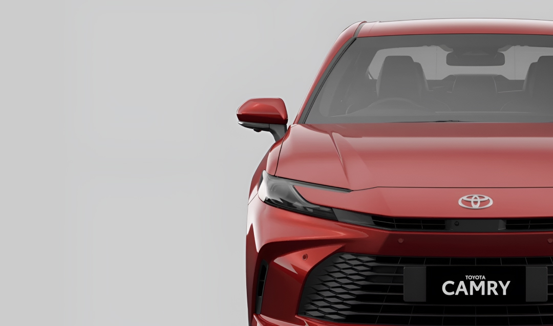 A front-facing red Toyota Camry sedan.