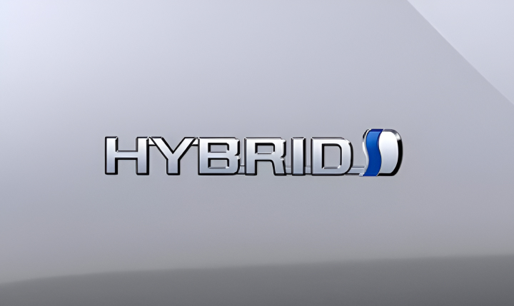 A close up of the Toyota Hybrid badge on a silver Prius.