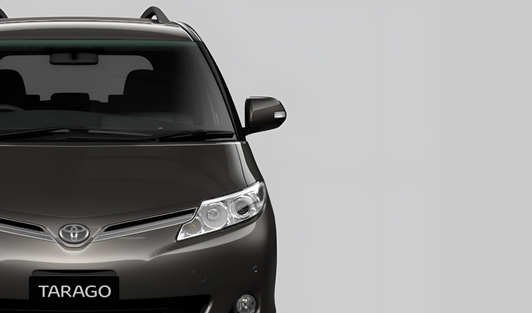 A front-facing black Toyota Tarago.