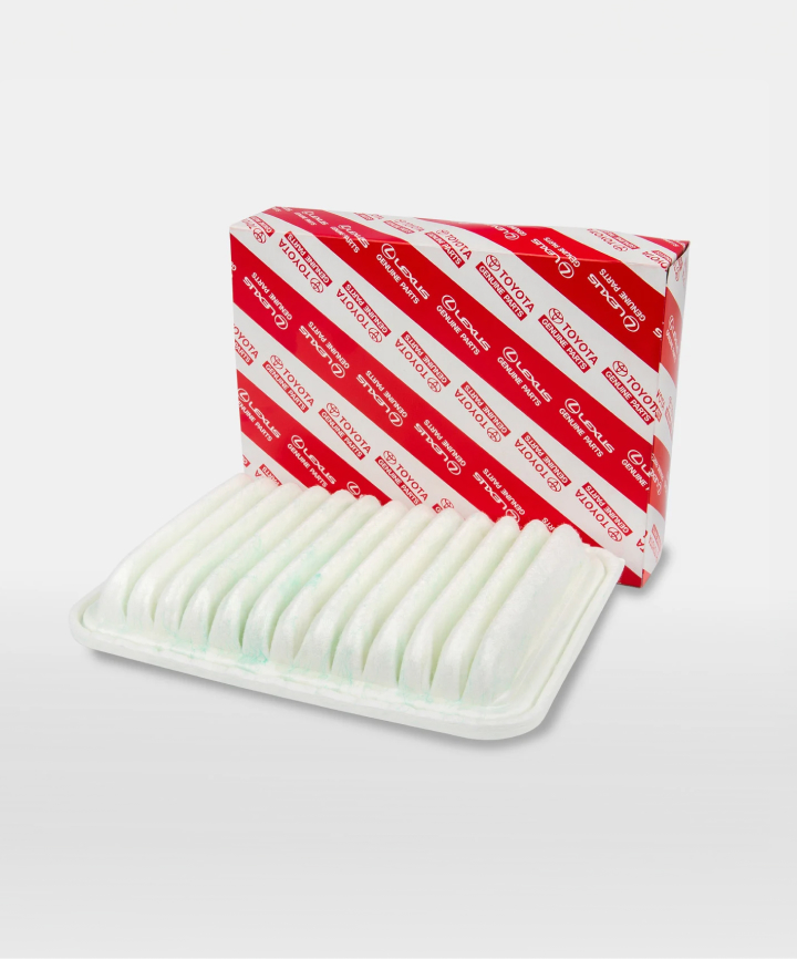A white air filter next to its red and white Toyota packaging.