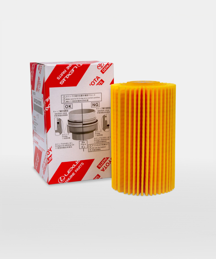 A yellow oil filter next to its red and white Toyota packaging.