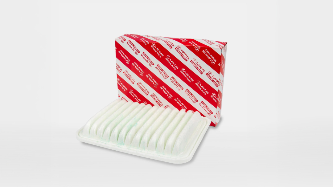 A white air filter next to its red and white Toyota packaging.