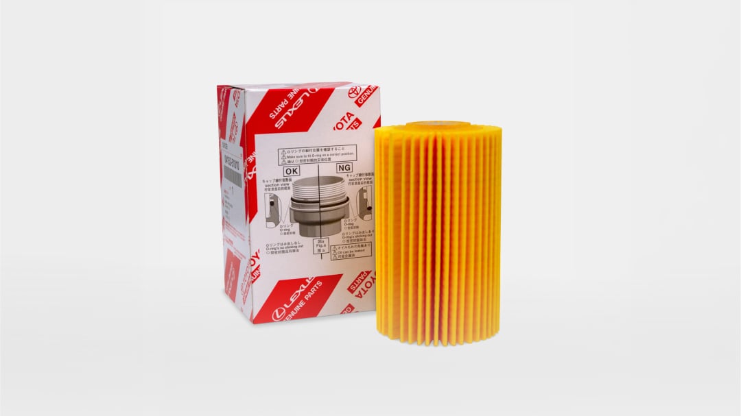A yellow oil filter next to its red and white Toyota packaging.