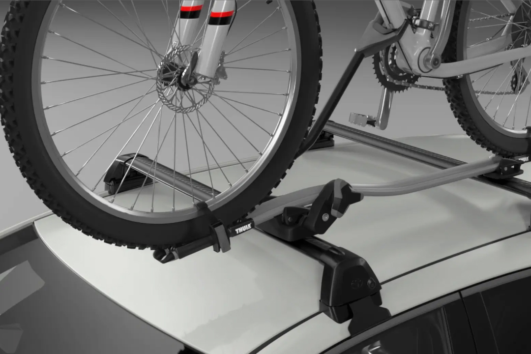A Pro Ride Bike Carrier carrying a bike, attached to a Toyota Genuine Roof Rack fitted to a G R Corolla in Glacier White.