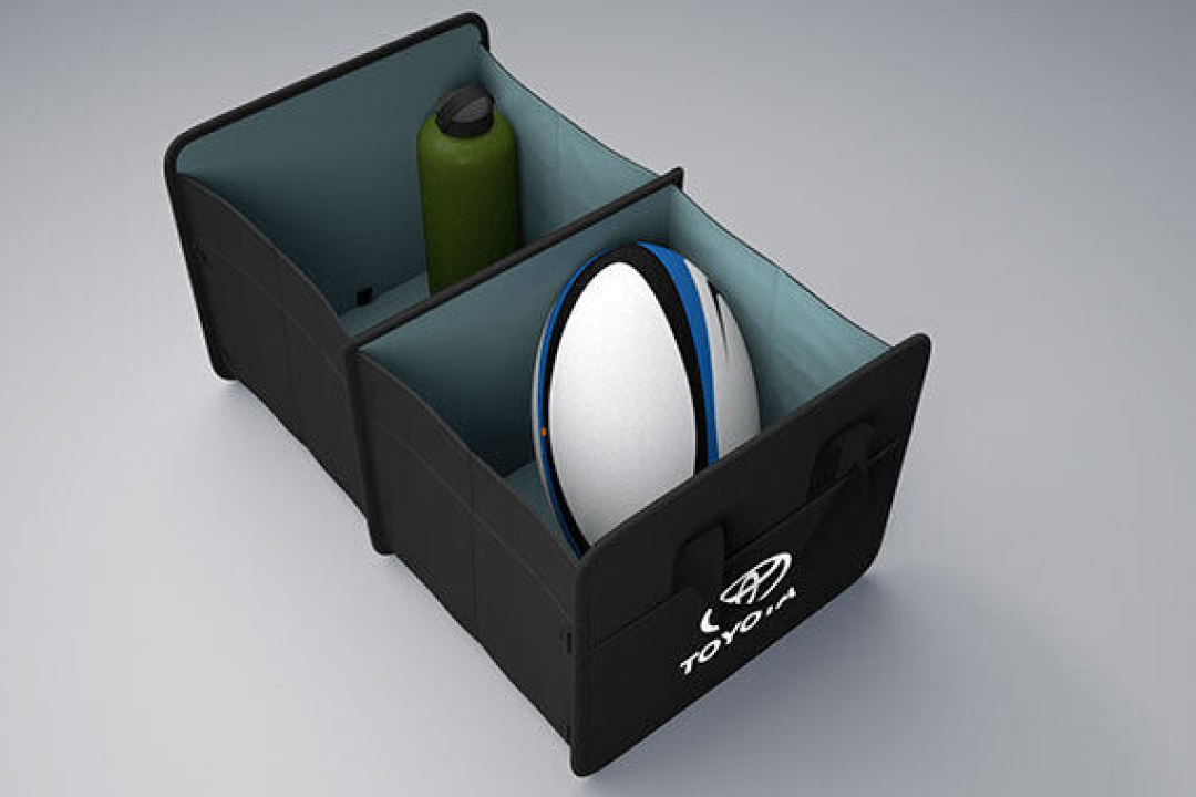 A Toyota Genuine Boot Organiser, holding a green reusable water bottle in one compartment, and a white and blue rugby ball in the other.