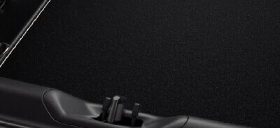 A black Toyota Genuine Cargo Mat installed into the boot floor of a G R Supra G T S.