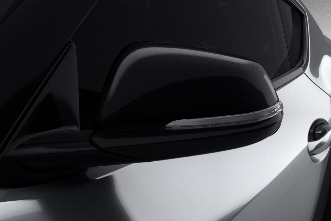 The front passenger rear view mirror on a G R Supra G T S in Nurburg Matte Grey, fitted with a Toyota Genuine Mirror Scalp.