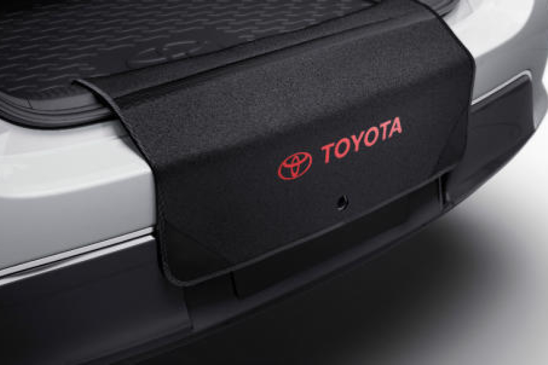 A Toyota Genuine Scuff guard hanging over the inner edge of a white G R Yaris' boot.