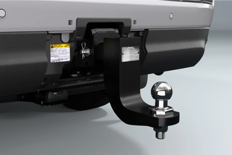 A close-up of a Toyota Genuine Towing Kit attached  to a vehicle, on a white studio background.