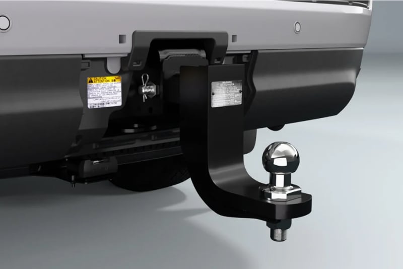 A close-up of a Toyota Genuine Towing Kit attached to a vehicle, on a white studio background.