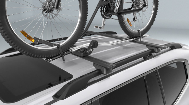 A Pro Ride Bike Carrier carrying a bike, attached to a Toyota Genuine Roof Rack fitted to a Toyota LandCruiser 300.