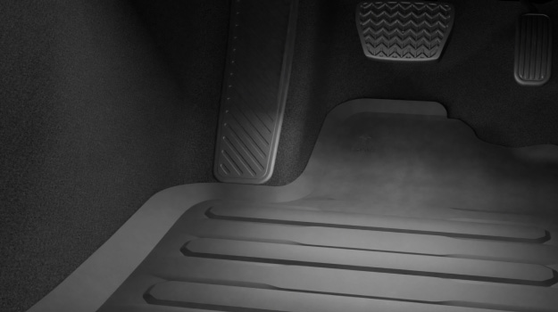 The interior of a Toyota vehicle featuring All Weather Rubber Floor Mats genuine accessory.