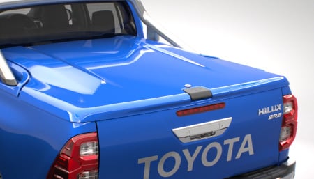 The rear of a Saturn Blue Toyota HiLux, featuring a Toyota Genuine Hard Tonneau Cover accessory.
