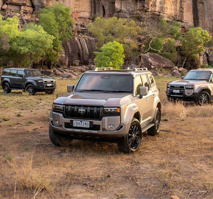 Toyota vehicles parked in an empty field