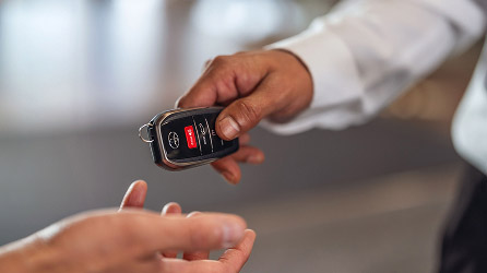 Dealer handing over keys to buyer